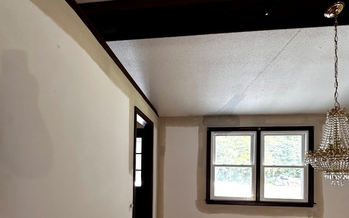 Window wall with spackle patches around the trim before painting