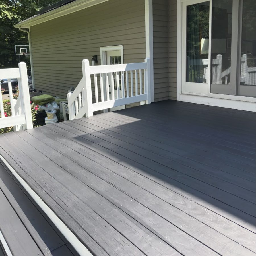 Charcoal-painted deck outside sliding doors with white railings